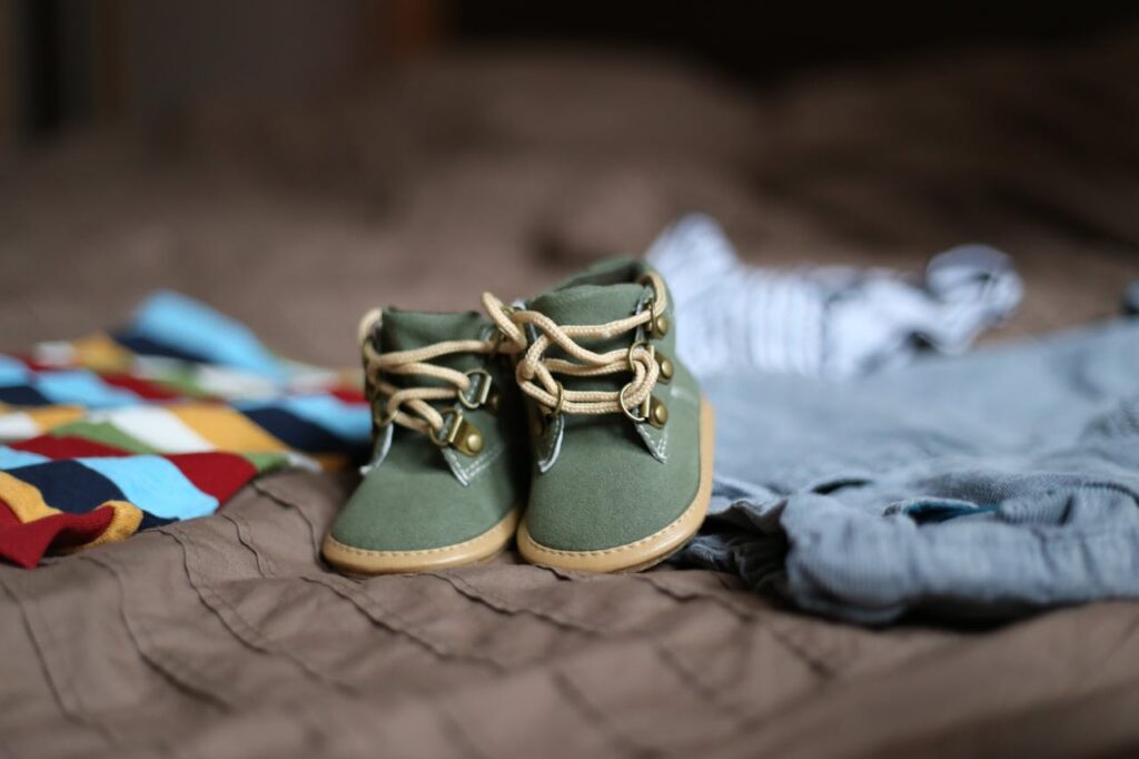 Babys Green and Beige Sneakers on Brown Textile